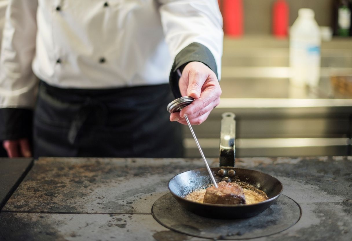 Chef using a food thermometer to monitor food temperature
