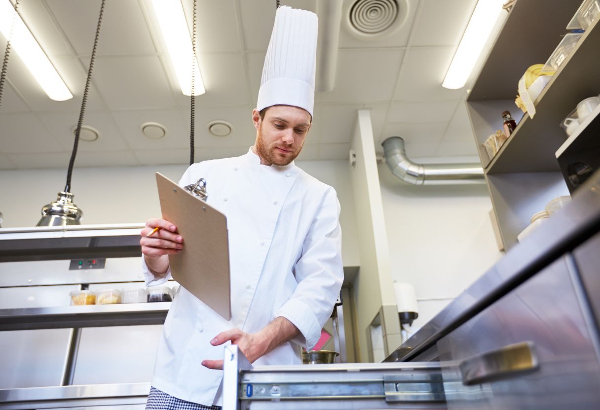 Chef inspecting kitchen equipment